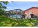 Backyard view of the pool and patio area, perfect for outdoor relaxation and entertaining at 11467 93Rd St, Largo, FL 33773