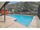 A refreshing pool in a screened enclosure surrounded by a spacious patio area at 11467 93Rd St, Largo, FL 33773