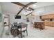 Open-concept dining area with beamed ceilings, tile floors, and views of the backyard pool at 11467 93Rd St, Largo, FL 33773