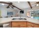 Open-concept kitchen with bar seating and views of the dining area and pool at 11467 93Rd St, Largo, FL 33773