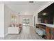 Bright living room with wood-look tile floors, modern decor, and sliding glass doors to the pool at 11467 93Rd St, Largo, FL 33773