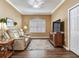 Inviting living area with a large television and decorative rug at 1167 Lindenwood Dr, Tarpon Springs, FL 34688