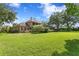 Expansive backyard features lush green grass and mature trees surrounding the beautiful home at 1203 Parrilla De Avila, Tampa, FL 33613