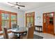 Bright breakfast area with a round dining table set next to multiple windows offering an outdoor view at 1203 Parrilla De Avila, Tampa, FL 33613