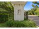Elegant entrance to Avila neighborhood with manicured landscaping and wrought iron gates at 1203 Parrilla De Avila, Tampa, FL 33613