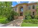 Stately brick home with a grand arched entryway and well-manicured landscaping at 1203 Parrilla De Avila, Tampa, FL 33613