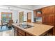 Bright kitchen featuring a large island with cooktop, custom cabinetry and a view into the dining area at 1203 Parrilla De Avila, Tampa, FL 33613