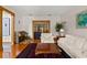 Bright living room with wood floors, a piano, and a view into the next room at 1203 Parrilla De Avila, Tampa, FL 33613