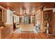 Warm, inviting living room featuring a fireplace, wood paneling, and outdoor views through sliding glass doors at 1203 Parrilla De Avila, Tampa, FL 33613