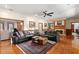Spacious living room featuring a fireplace, hardwood floors, and comfortable leather sofas at 1203 Parrilla De Avila, Tampa, FL 33613