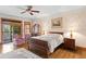 Spacious main bedroom featuring hardwood floors, ceiling fan, and access to a balcony with sliding glass doors at 1203 Parrilla De Avila, Tampa, FL 33613