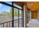 Covered patio offering a view of the pool and lush landscaping with mature trees in the background at 1203 Parrilla De Avila, Tampa, FL 33613