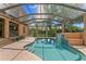 Screened pool with brick detailing, lush landscaping, and clear blue water perfect for relaxation and recreation at 1203 Parrilla De Avila, Tampa, FL 33613