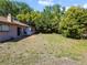 Expansive backyard featuring a well-maintained lawn, mature trees, and private outdoor space at 12808 Candlewood Way, Hudson, FL 34667