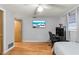 Bright bedroom features a ceiling fan, a television and a small desk area at 12808 Candlewood Way, Hudson, FL 34667