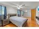 Bedroom with ceiling fan, wood floors, and furnishings, connected to a bonus room at 12808 Candlewood Way, Hudson, FL 34667