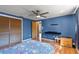 Bedroom featuring wood flooring, a ceiling fan and a large closet with sliding doors at 12808 Candlewood Way, Hudson, FL 34667