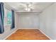 Bright bedroom featuring wood-look flooring, neutral walls, and a large window at 12808 Candlewood Way, Hudson, FL 34667