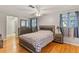 Spacious bedroom with wood flooring, a ceiling fan, and a dresser with mirror at 12808 Candlewood Way, Hudson, FL 34667