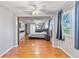 Spacious Primary bedroom with wood floors, ceiling fan, ensuite bathroom, and tv at 12808 Candlewood Way, Hudson, FL 34667