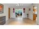 An empty dining room with brick-tile flooring and open access to another room at 12808 Candlewood Way, Hudson, FL 34667