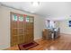 Inviting front entry with decorative doors, hardwood floors, and ample natural light at 12808 Candlewood Way, Hudson, FL 34667