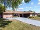 Charming single-story home with a well-manicured lawn, mature landscaping, and a two-car garage at 12808 Candlewood Way, Hudson, FL 34667