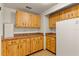 Bright kitchen featuring wood cabinetry, tile flooring, and plenty of counter space at 12808 Candlewood Way, Hudson, FL 34667