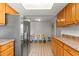 Bright kitchen with stainless steel refrigerator, wooden cabinets, and eat-in dining area at 12808 Candlewood Way, Hudson, FL 34667