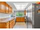 Functional kitchen with wooden cabinets, tile backsplash, and stainless steel appliances at 12808 Candlewood Way, Hudson, FL 34667