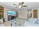 Bright living room with neutral walls, tile floors, and a ceiling fan at 12808 Candlewood Way, Hudson, FL 34667