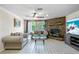 Comfortable living room featuring tile flooring, a stone fireplace, and a sliding glass door to the back at 12808 Candlewood Way, Hudson, FL 34667