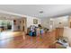 Open-concept living area with hardwood floors and plenty of room for furniture and decor, but filled with boxes at 12808 Candlewood Way, Hudson, FL 34667