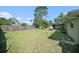 Well-maintained backyard with an enclosed patio and a lush lawn at 1371 Meredith Dr, Spring Hill, FL 34608