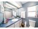 Bathroom with blue walls, white cabinets, and a window for natural light at 1371 Meredith Dr, Spring Hill, FL 34608