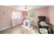 Pink Bedroom with nail salon, salon chair, manicure station, and hardwood floors at 1371 Meredith Dr, Spring Hill, FL 34608