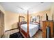 Bedroom with a four poster bed, light wood floors, and a ceiling fan at 1371 Meredith Dr, Spring Hill, FL 34608