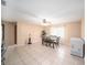 Bright dining room with tile floors, a ceiling fan, and a dining set next to the kitchen at 1371 Meredith Dr, Spring Hill, FL 34608