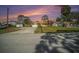 Charming single-story home featuring stone accents, attached garage, and a long driveway at sunset at 1371 Meredith Dr, Spring Hill, FL 34608