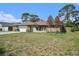 Charming single-story home featuring stone accents, attached garage, and a grass yard at 1371 Meredith Dr, Spring Hill, FL 34608