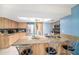 Bright kitchen features granite countertops, stainless steel appliances, breakfast bar and a skylight at 1371 Meredith Dr, Spring Hill, FL 34608