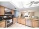 Bright kitchen features stainless appliances, granite countertops, tile backsplash and a skylight at 1371 Meredith Dr, Spring Hill, FL 34608