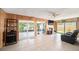 Wood paneled living room featuring large windows, tile floors, and comfortable furniture at 1371 Meredith Dr, Spring Hill, FL 34608
