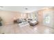 Cozy living room featuring tile floors, a neutral sofa, and large windows at 1371 Meredith Dr, Spring Hill, FL 34608