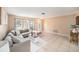 Relaxing living room with tile floors, a comfortable sofa, and lots of natural light at 1371 Meredith Dr, Spring Hill, FL 34608