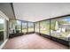 Enclosed sunroom featuring tile floors and access to the backyard at 1371 Meredith Dr, Spring Hill, FL 34608