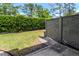 Private backyard featuring a lawn area and a privacy fence lined with lush greenery at 14053 Notreville Way, Tampa, FL 33624