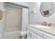 Clean bathroom featuring a shower-tub combo, white vanity, and classic tile at 14053 Notreville Way, Tampa, FL 33624