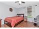 Bedroom with hardwood floors, bright window, and a comfortable area for relaxation at 14053 Notreville Way, Tampa, FL 33624