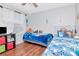 Comfortable bedroom with hardwood floors, bright window, and ample natural light at 14053 Notreville Way, Tampa, FL 33624